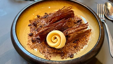 pracownicy hotelowej restauracji w strojach kelnerskich przygotowujący danie